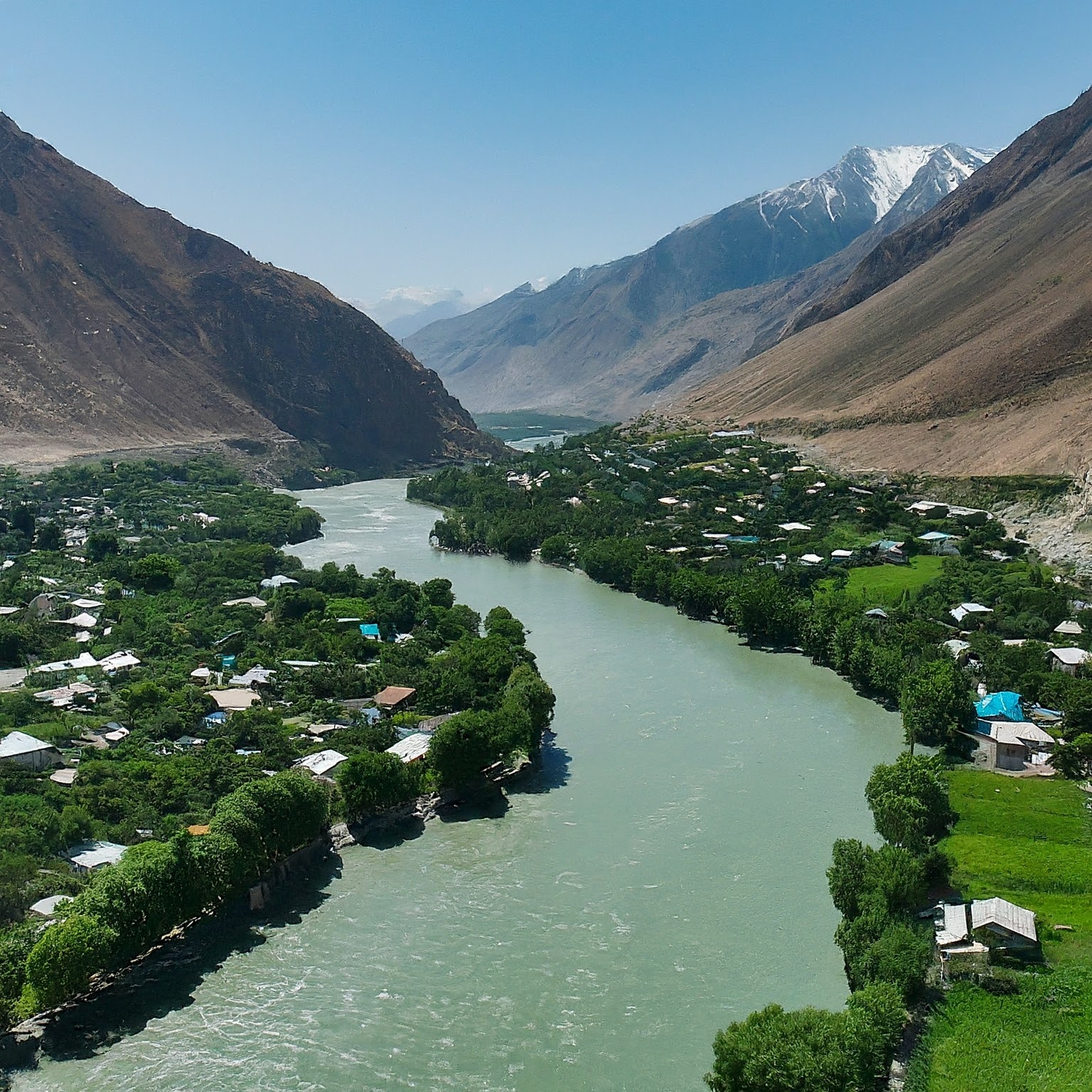 The Panj River flowing through Kalaikhum, Tajikistan, with mountains in the distance.