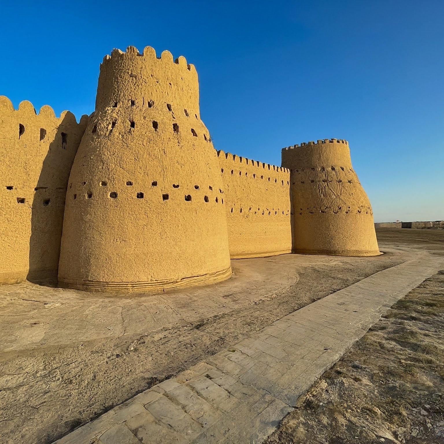 Sarakhs Fortress in Turkmenistan, a UNESCO World Heritage Site, with mudbrick walls and towers.
