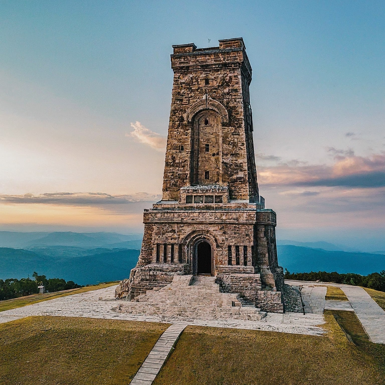 The Shipka Monument, a symbol of Bulgarian freedom, overlooks a scenic mountain landscape.