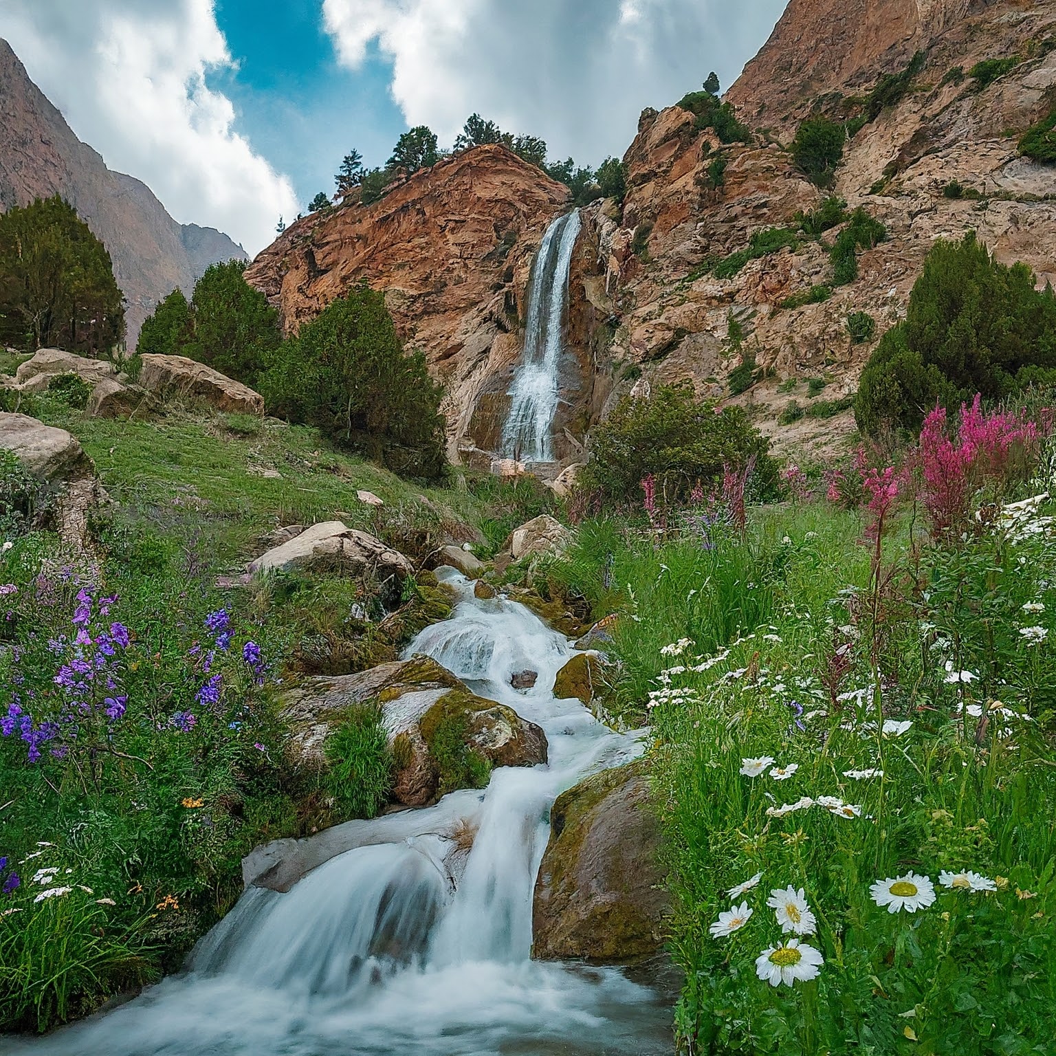 Waterfall cascading down a mountainside in Varzob, Tajikistan.