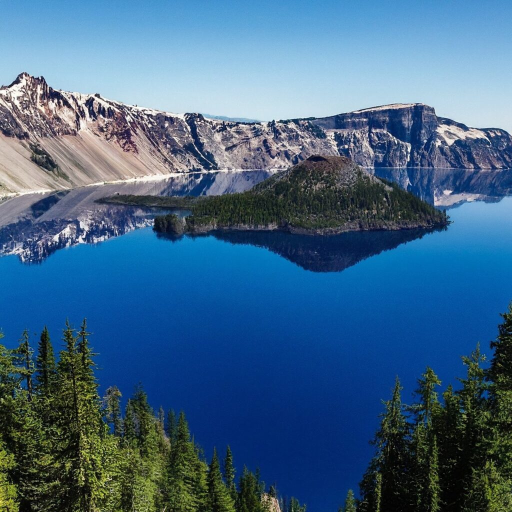 Breathtaking view of Crater Lake, a deep blue volcanic lake surrounded by mountains.